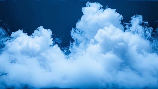 a group of clouds of smoke floating in the air on a dark blue background with a light reflection on the bottom of the image.