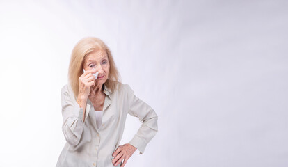 Unwell sadness grandmother use tissue absorb eyes closed crying standing over isolated white...