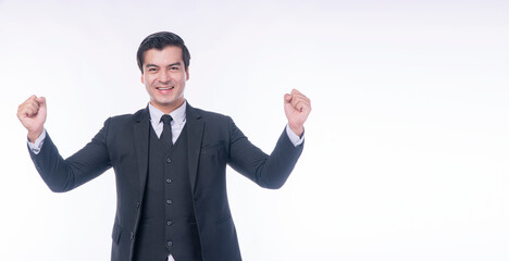 Excited successful handsome businessman raising hand up smile toothy standing over isolated white background. Caucasian victory manager man wear suit raising hand excitement gesture winner success.