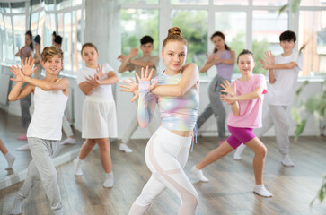 Group of boys and girls rehearsing jazz funk dance in studio