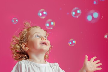 Obraz na płótnie Canvas Girl's Bubble Bliss Against Vibrant Pink