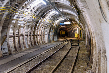 Fototapeta na wymiar Coal mine tunnel with rail tracks