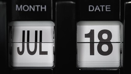 retro flip calendar with a date change from the seventeenth of July to the eighteenth of July. daily calendar with a change of days of the month. close up.