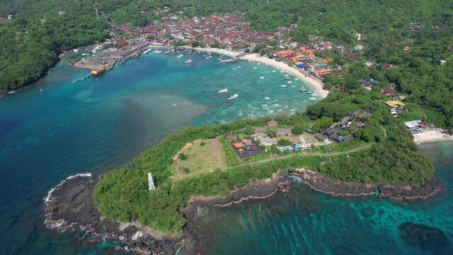 Forward reveal drone footage of Padangbai Bay and Pura Luhur Silayukti hindu temple on sunny day. Manggis, Bali, Indonesia.