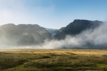 Fototapeta na wymiar Mist over the glacier and mountains landscape in Icelandic countryside