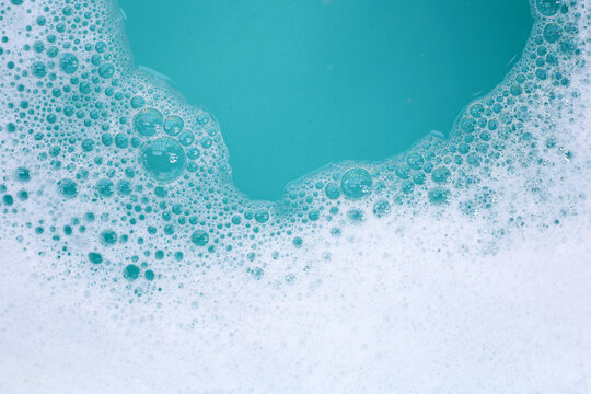 Detergent foam bubble on water. Blue background, Soap sud