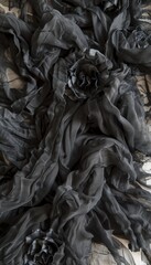 Elegant black silk fabric texture for sophisticated and delicate background designs.