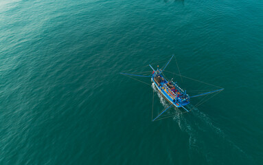 The wooden fishing boat of Vietnamese fishermen is running at sea.