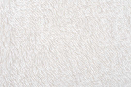 white plush fabric texture background, background pattern of soft warm material