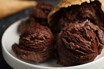 Tasty ice cream scoops on plate, closeup
