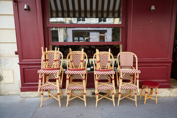 Rattan Chairs Stacked in Front of a Restaurant