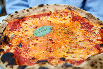 Close Up of Whole Pizza with Basil Leaf