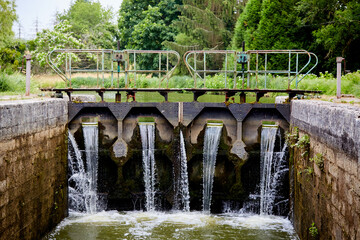 Fototapeta premium Water Rushing into a Canal Lock on the Yonne River