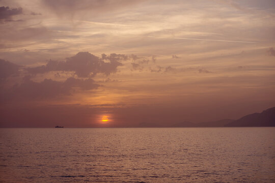 seascape purple sunset on the sea. calm sea and sunset. mountains, sea, sunset. calm seascape