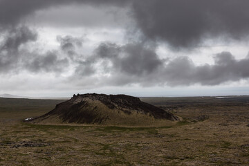 Dramatic lava fields in Iceland's Snaefellsnes Peninsula under a cloudy sky. Volcanic, desolate,...