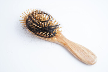 Hair loss fall with comb brush isolated on white background.