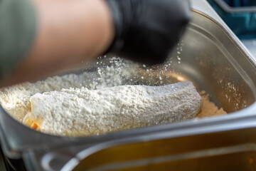 Authentic breading process of a cordon bleu schnitzel