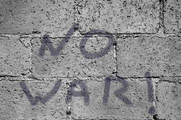 Conceptual graffiti on tuff wall against war
