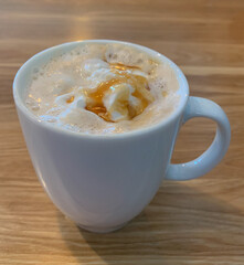 A delicious coffee cocktail drizzled with caramel. Caramel latte.