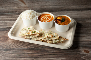 A view of a garlic naan combo meal.