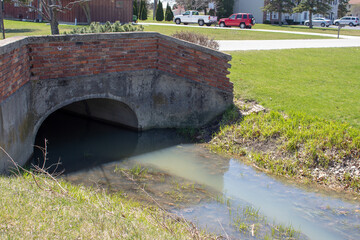 A bridge over a water ditch.