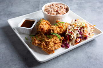 A view of a plate of Jamaican fried chicken.