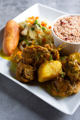 A view of a plate of curry chicken.