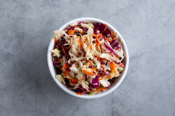 A top down view of a bowl of cabbage slaw.