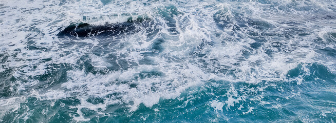 Dynamic ocean waves texture with space for text, suitable as a vibrant natural background for...