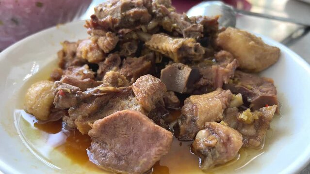Cooked goose duck in Vietnam on the table with cut pieces of meat with broth sauce that pours over the rice. delicious homemade food in family