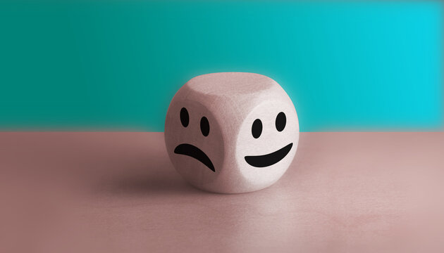 Good mental health and bad mood concepts Smiley's face on the bright side and a sad face on the dark side on the wooden block cube for positive mindset selection.