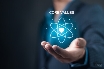 Core values responsibility ethics goals company concept. Businessman holding Core Values icon on virtual screen.