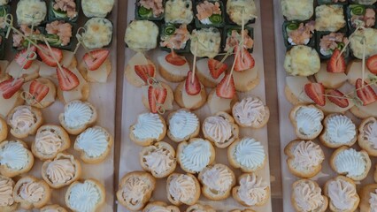 Catering on a banquet table with appetizers-canapes in a restaurant or hotel. Snacks on the table, catering concept. buffet food set for corporate day celebration.