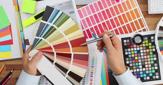 Office worker takes moment to select colour using palette