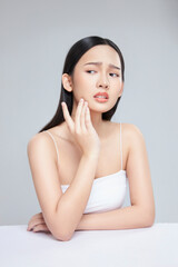 Young Asian woman touch and worry about her face. Acne, pimple, clear and clean, oily, dry skin...
