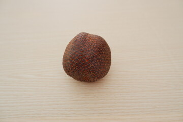 Salak fruit on wooden background, Salacca zalacca.