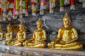 The gold Buddha statue in the cave at Wat Tham Khuha Sawan, Khong Chiam district, Ubon Ratchathani, Thailand