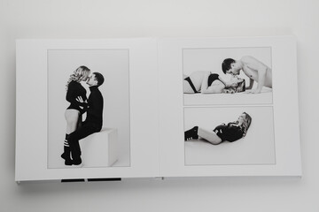 The pages of a photo book with a photo of a pregnant blonde and a man. 