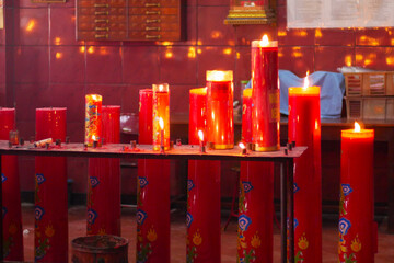 Candles for worship lit in a monastery in Jakarta's Chinatown area