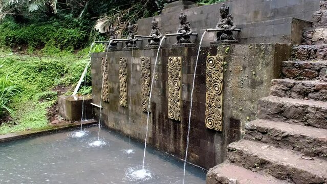 Tripod footage of a pool for pilgrims nearby Air Terjun Jagasatru waterfall. Bali, Indonesia.