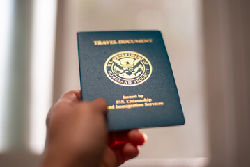 USA Re-entry Permit holding in hand with soft background and shallow focus