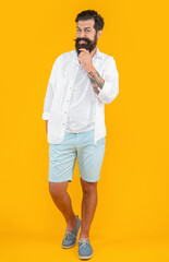 photo of bearded guy wearing summer fashion. bearded guy isolated on yellow. bearded guy