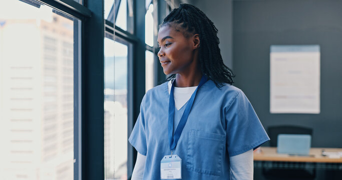 Nurse, healthcare and thinking at window of hospital with ideas for surgery, medical decision and happy. Medicine, black woman and professional intern thoughtful in the clinic with wonder and smile