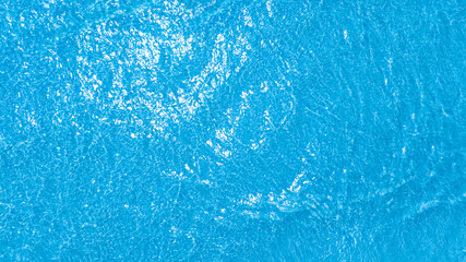 Top view Deep sea waves, blue surface, of ocean navigation. There are ripples and bubbles. The sunlight shines brightly