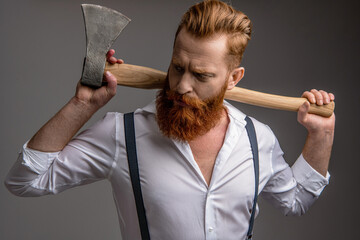 Handsome and charismatic. Masculine man. Shiny hair. Masculinity of bearded man with axe isolated...