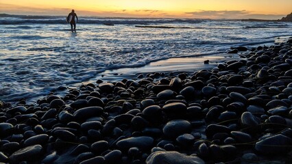 Southern California beach scenes with sunsets, surfers, tide pools and palms trees at Swamis Reef Surf Park and Moonlight Beach in Encinitas California. - obrazy, fototapety, plakaty