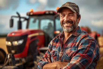 Foto op Canvas A smiling male tractor driver standing in front of tractor. © Bargais