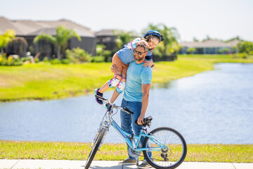 childhood of son supported by fathers care. father and son on bicycle at fathers day. active father setting a example for fathers son. fathers parenting with son outdoor. strong bond