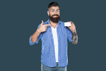 glad bearded man showing blank debit card with copy space