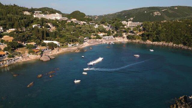 Tour boat weaves between vessels to park and anchor in bay of Corfu Greece